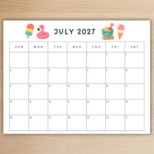 May include: A July 2027 monthly calendar page featuring a grid layout with black text and lines. The header includes illustrations of a colorful popsicle, a pink flamingo float, a blue sand bucket with a shovel, and a pink ice cream cone.