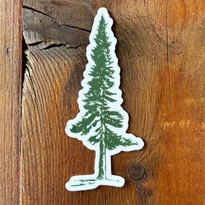 Peut inclure: Autocollant vert et blanc représentant un arbre de conifère stylisé. L'arbre est représenté dans un style illustratif détaillé avec une bordure blanche. L'autocollant est placé sur une surface en bois rustique.
