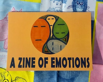 Könnte beinhalten: Ein gelbes und oranges Zine mit dem Text "A Zine of Emotions" und einem farbenfrohen abstrakten Design eines Kreises mit vier Abschnitten.