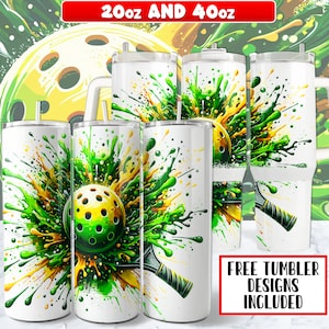 May include: Four stainless steel tumblers with a green and yellow paint splatter design featuring a pickleball and paddle. The tumblers are available in 20 oz and 40 oz sizes. "FREE TUMBLER DESIGNS INCLUDED" is written in red text on a white background.