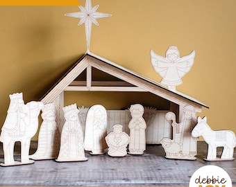 May include: A wooden nativity scene with a star, angel, and various figures. The scene includes a stable, wise men, Mary, Joseph, baby Jesus, a donkey, and a sheep. The text "Laser tested" and "SVG laser ready files | Digital download" are visible.