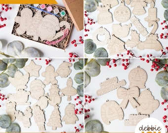 May include: A set of 18 laser-cut wooden Christmas ornaments ready for painting. The ornaments feature various holiday themes, including a snowman, a gingerbread man, a penguin, a Christmas tree, a reindeer, a nutcracker, a ballerina, a snowflake, a bell, a candy cane, a stocking, a wreath, a present, a snow globe, a hot chocolate mug, a sweater, and a "Merry Christmas" banner. The ornaments are arranged on a white background with red berries and greenery.