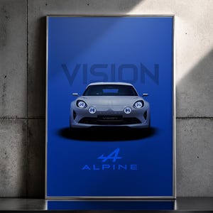 May include: Framed poster featuring a silver Alpine Vision car against a deep blue background. The word "VISION" is at the top, with "44 ALPINE" at the bottom. The car has round headlights.