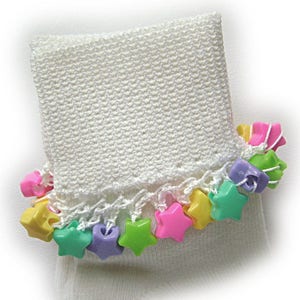 May include: White socks with a crocheted trim and colorful star-shaped beads.