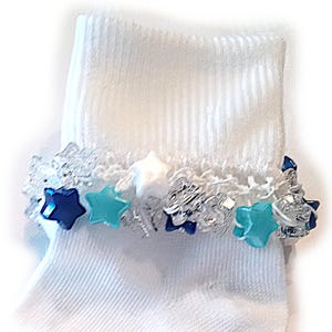 May include: White ankle socks with a lace trim and blue and turquoise star-shaped embellishments.