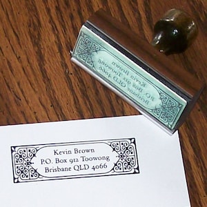 May include: A black and white rubber stamp with a decorative border and the text "Kevin Brown, P.O. Box 912 Toowong, Brisbane QLD 4066".