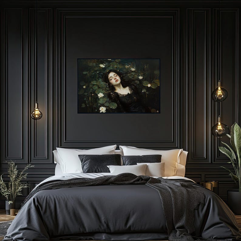 May include: A framed artwork showing a woman in a black dress in water with lily pads and white flowers. The artwork is on a black wall above a bed with dark grey bedding and white pillows. Decorative hanging lights are on either side of the artwork.