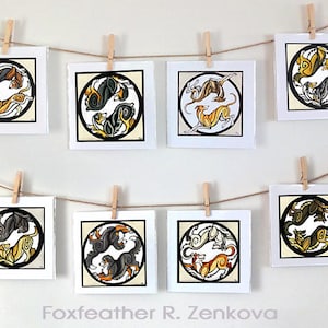 May include: Eight framed illustrations of stylized black, white, and gold dogs in a circular design. The illustrations are hung on a wall with string and clothespins. The text "Foxfeather R. Zenkova" is at the bottom of the image.