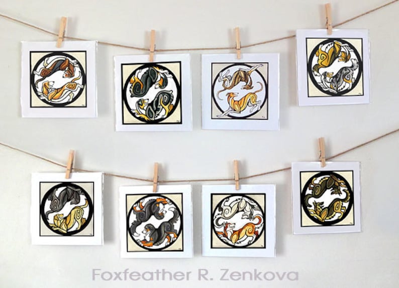 May include: Eight framed illustrations of stylized black, white, and gold dogs in a circular design. The illustrations are hung on a wall with string and clothespins. The text "Foxfeather R. Zenkova" is at the bottom of the image.