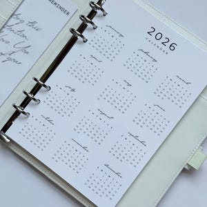 May include: A set of three ceramic mugs with a speckled, matte finish. The mugs are in shades of cream, light gray, and dark gray. Each mug has a simple, minimalist design, perfect for coffee or tea.