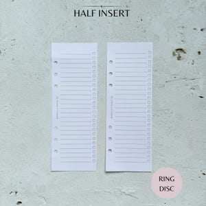 May include: Two white planner half inserts with lined pages and check boxes. The text "HALF INSERT" is at the top, and "RING DISC" is at the bottom right. The inserts have pre-punched holes for binding.