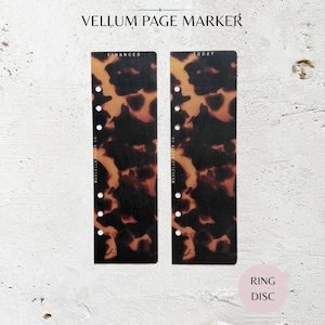 May include: Two vellum page markers with a tortoiseshell pattern. One marker reads "Finances" and the other reads "Today". Each marker has a series of holes for ring binding. The text "Vellum Page Marker" is at the top.