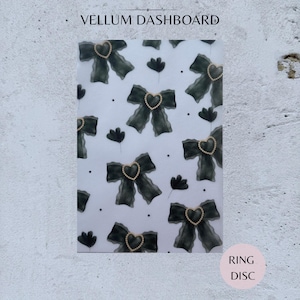 May include: A translucent vellum dashboard featuring a repeating pattern of dark green bows, each centred with a small heart outlined in white pearls, interspersed with tiny black dots and small dark green floral shapes, labelled VELLUM DASHBOARD.