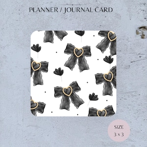 May include: A planner or journal card with a white background featuring a pattern of black bows with gold heart centres and black flower accents. The card is 7.6 x 7.6 cm and has the text "PLANNER / JOURNAL CARD".