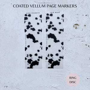 May include: Two coated vellum page markers with a dalmatian-style pattern of black spots on a white background. One marker reads "High Priority" and the other reads "This Week". The text "Marcella Paper Co" is printed vertically on each marker.