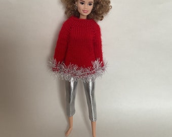 Red hand knitted sweater and silver color trousers