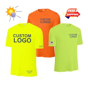 May include: Three short-sleeved t-shirts in bright colors: yellow, orange, and lime green. Each shirt has the words "CUSTOM LOGO" printed in navy blue. The lime green shirt has a small American flag patch. A sun graphic and a "FREE SHIPPING" banner are also visible.