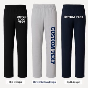 May include: Three pairs of sweatpants in black, gray, and navy blue. Each pair features a different design: custom logo text on the hip, custom text down the leg, and custom text on the butt. The sweatpants have an elastic waistband.