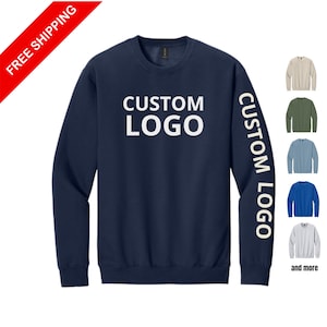 May include: Navy blue sweatshirt with the text "CUSTOM LOGO" on the front and sleeve. Additional color options are displayed to the right, including tan, green, blue, and gray.