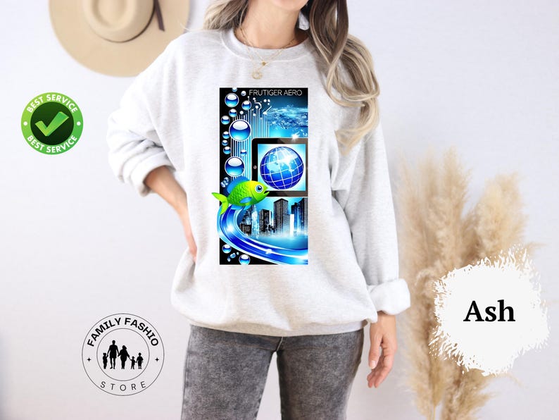 May include: Light gray sweatshirt with a colorful graphic. The graphic features a digital design with a globe, cityscape, and a green fish. The text "FRUTIGER AERO" is at the top of the graphic.