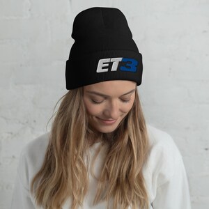 May include: Black beanie with a white and blue embroidered logo that says "ET3".
