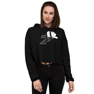 May include: Black cropped hoodie with a white graphic of a number 7 with a baseball cap on top.