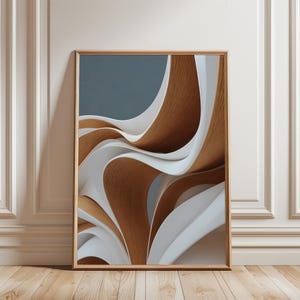 May include: Abstract art print in a wooden frame. The artwork features flowing, layered shapes in shades of brown, white, and gray against a muted blue background. The design creates a sense of movement and depth, suitable for modern decor.