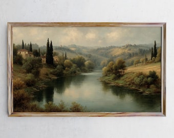 Puede incluir: Pintura de paisaje enmarcada que representa un río sereno que serpentea a través de colinas. La obra de arte presenta una paleta de colores apagados de verdes, marrones y azules, con edificios y árboles altos a lo largo del río. El marco es de madera clara.