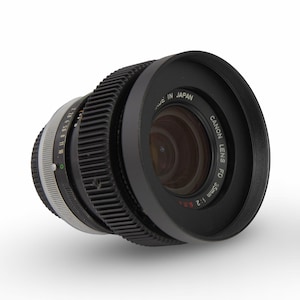 May include: A black Canon FD 35mm f/2 lens with a silver ring and a black lens cap. The lens cap has the text "Canon FD 35 f/2 0.3m" printed on it.