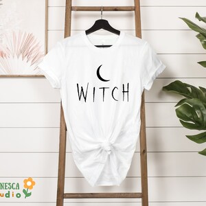 a white t - shirt with the word witch printed on it