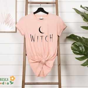 a t - shirt that says witch hanging on a ladder
