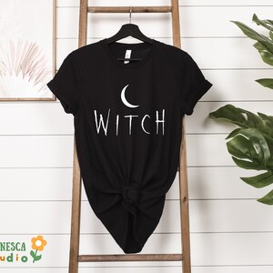 a black t - shirt with the word witch printed on it