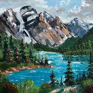 May include: An oil painting depicts a mountain landscape with a turquoise lake and evergreen trees. The mountains have snow-capped peaks and are painted in shades of brown, gray, and white. The sky is a mix of blue and gray.