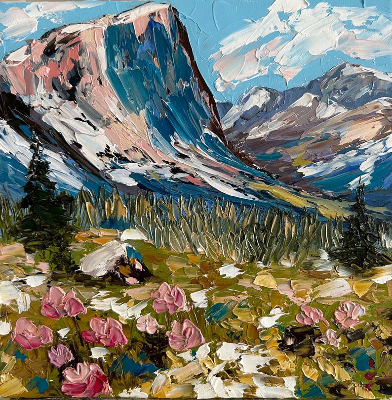 May include: An oil painting depicts a mountain landscape with a large, snow-capped peak in shades of blue, pink, and white. The foreground features pink flowers and green foliage. The sky is a light blue with white clouds.