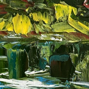 May include: Close-up of an abstract oil painting with thick brushstrokes. The artwork features a vibrant mix of colors, including yellow, green, blue, and red. The textured surface creates a dynamic and expressive visual effect, suggesting a landscape or natural scene.
