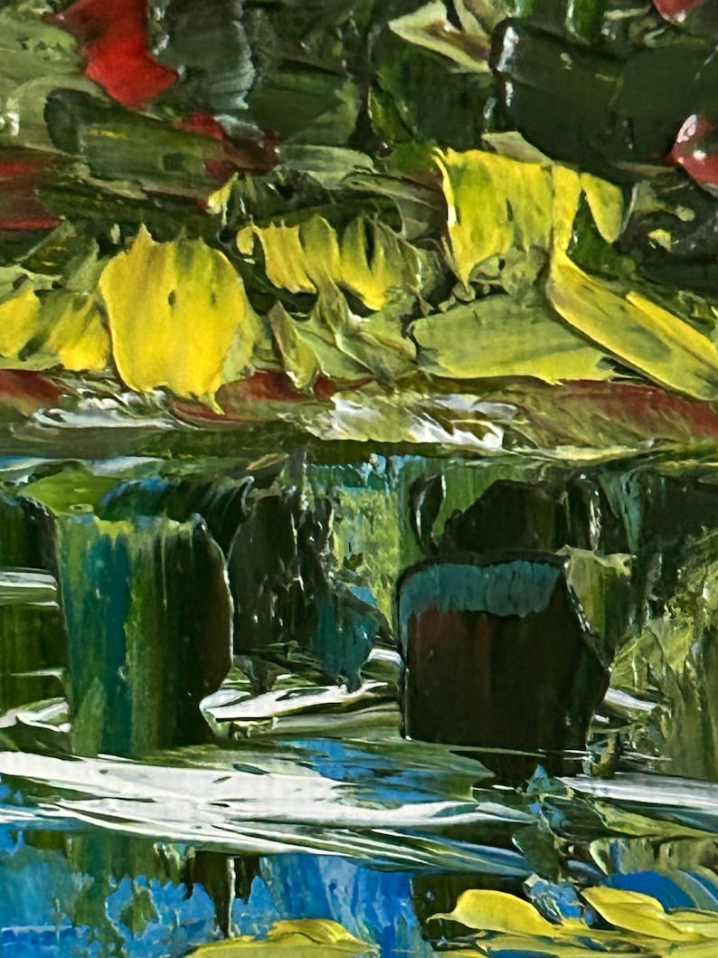 May include: Close-up of an abstract oil painting with thick brushstrokes. The artwork features a vibrant mix of colors, including yellow, green, blue, and red. The textured surface creates a dynamic and expressive visual effect, suggesting a landscape or natural scene.