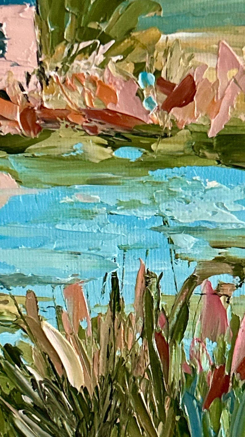 May include: An oil painting on canvas featuring a textured landscape with thick impasto brushstrokes. The scene displays a bright blue body of water surrounded by tall green grasses and foliage in shades of pink, orange, and muted earth tones.