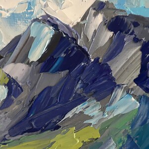 May include: An abstract oil painting of a mountain range. The artwork features textured brushstrokes in shades of blue, gray, white, and green. The painting evokes a sense of depth and the rugged beauty of nature.