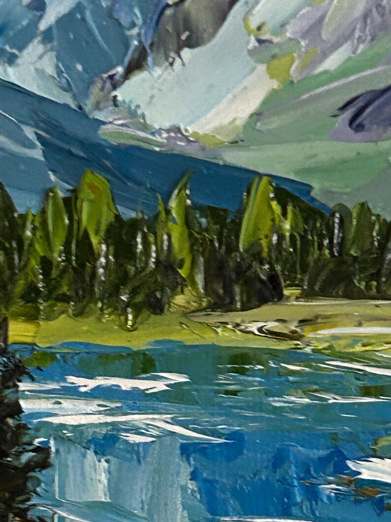 May include: An impressionistic painting of a mountain landscape. The artwork features a vibrant blue lake in the foreground, with green trees and a mountain range in the background. The sky is a mix of blue and white, with visible brushstrokes.
