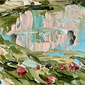 May include: An oil painting featuring thick impasto brushstrokes depicting a pink building with a blue door, reflected in a body of water. The foreground shows green foliage with small red flower buds, rendered in a textured, layered paint style.
