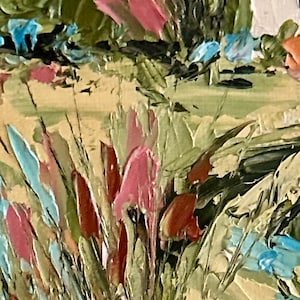 May include: An oil painting on canvas featuring a textured landscape with thick impasto brushstrokes. The scene displays a field of tall grasses in shades of sage green, tan, and pink, accented by bright blue flowers and a white structure in the distance.