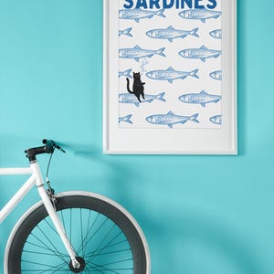Featuring a retro-inspired blue sardine pattern on a crisp white background, this design stands out with a playful black cat floating among the fish, blowing bubbles. A perfect mix of vintage charm and quirky humor.