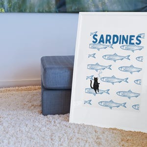 Featuring a retro-inspired blue sardine pattern on a crisp white background, this design stands out with a playful black cat floating among the fish, blowing bubbles. A perfect mix of vintage charm and quirky humor.