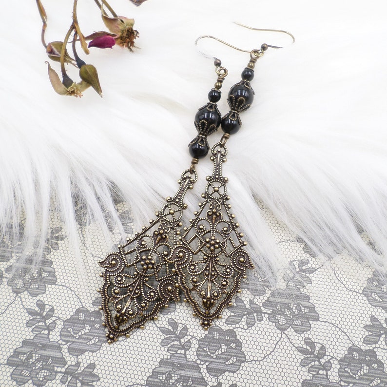 gorgeous large antique brass filigree pendants are accented by me with top quality black pearls.