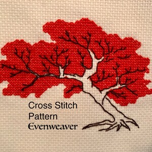 May include: Cross stitch pattern of a red tree with a white trunk and black branches. The pattern is titled "Evenweaver".