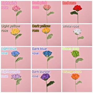 May include: Twelve crocheted roses in various colors, including light pink, dark pink, red, light yellow, dark yellow, white, light blue, dark blue, green, light purple, dark purple, and orange. Each rose is on a green stem with leaves.