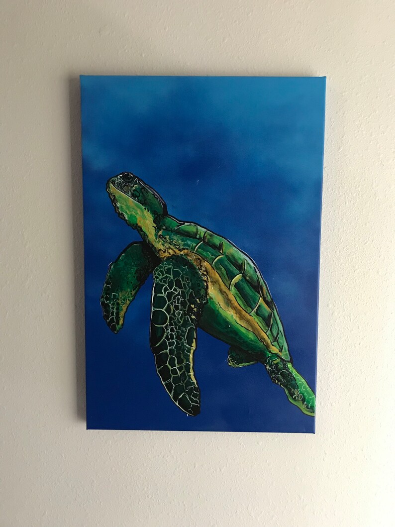 May include: A green sea turtle swimming in a blue ocean. The turtle is painted in a realistic style with detailed scales and a yellow stripe on its shell.