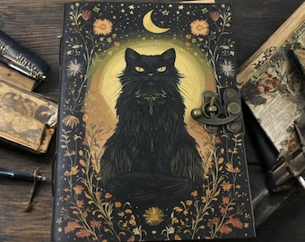 May include: A decorative journal with a black cat illustration. The cover features a black cat with yellow eyes, set against a golden moon and floral accents. The journal has a clasp closure and is surrounded by other books.