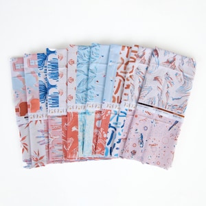 May include: A collection of fabric bundles in various patterns and colors. The fabrics feature designs in shades of blue, pink, and orange, with abstract and botanical motifs. The bundles are neatly stacked, showcasing the diverse patterns.