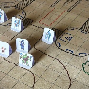 May include: A tabletop game board with a brown grid pattern and black and blue lines. There are seven miniature figures on the board, including a wizard, a warrior, a goblin, and a ranger. The figures are on white cardboard bases.